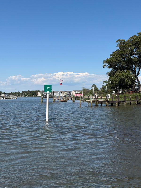 A channel marker in a working harbor