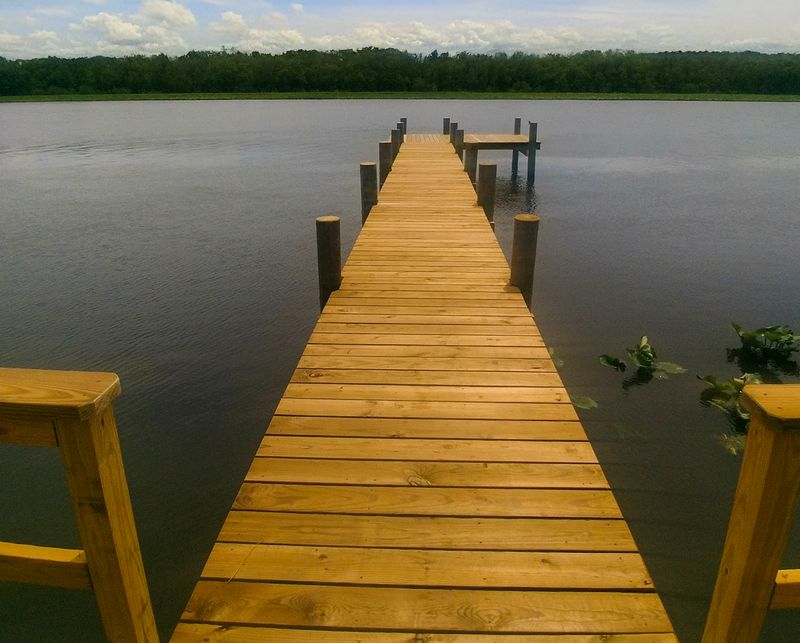 A long timber pier across the marsh