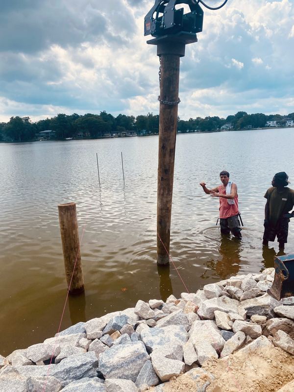 Shoreline rip-rap revetment, stone boat ramp and new pier and dock