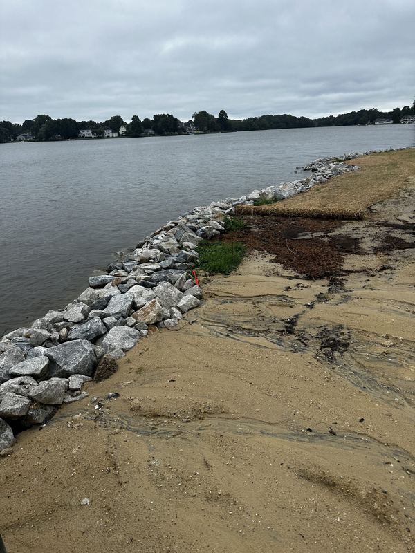 Shoreline rip-rap revetment, stone boat ramp and new pier and dock