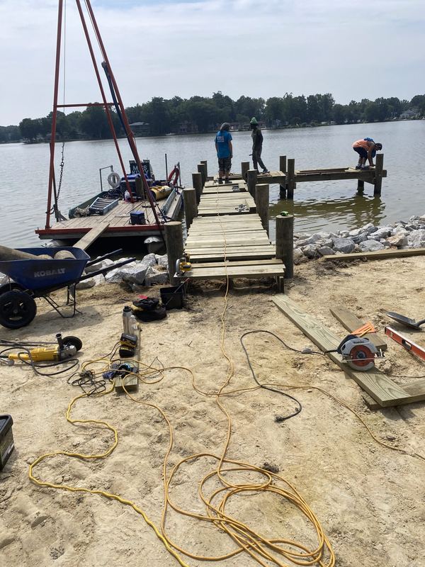 Shoreline rip-rap revetment, stone boat ramp and new pier and dock